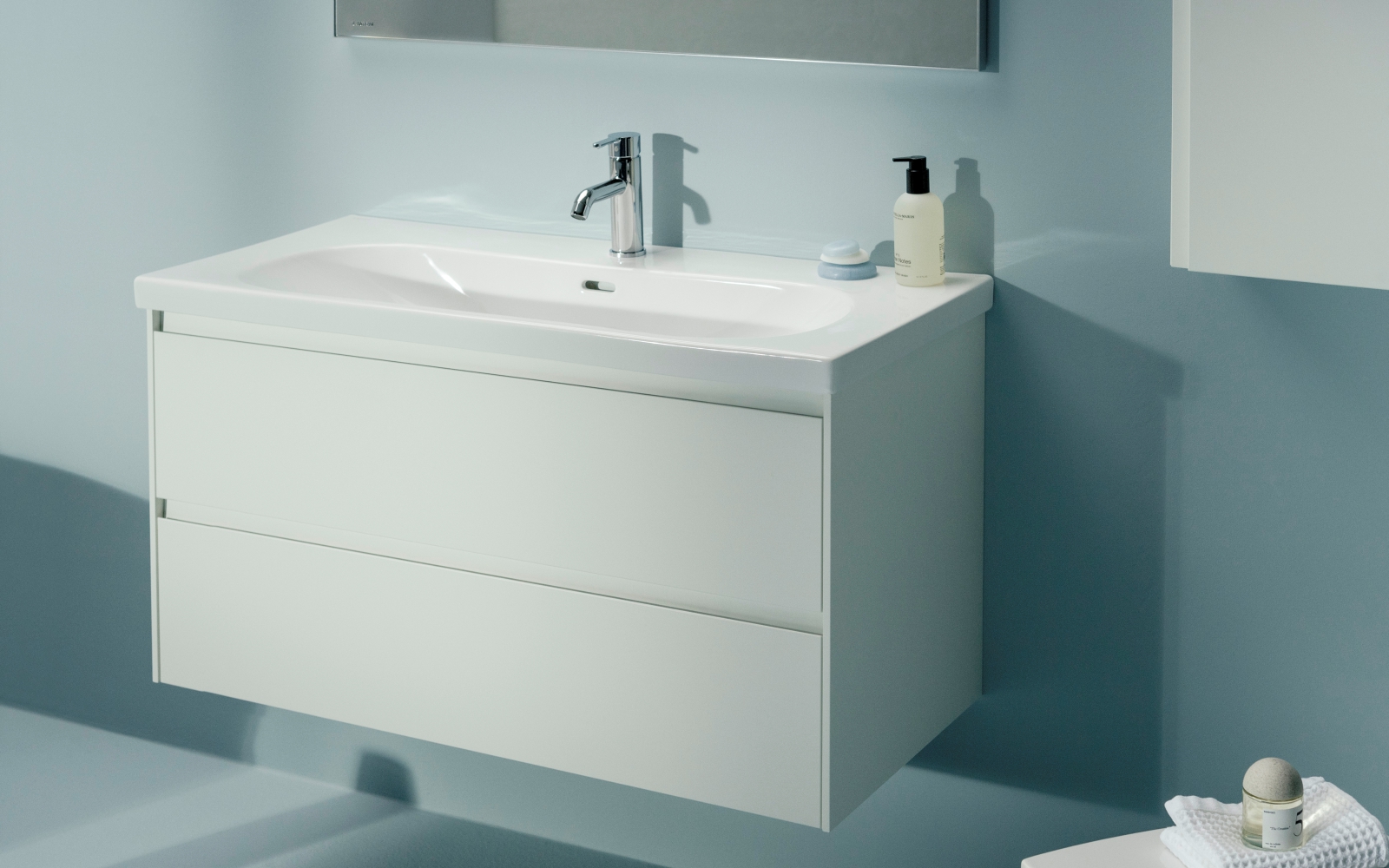 Laufen wall-hung toilet and white bathroom furniture
